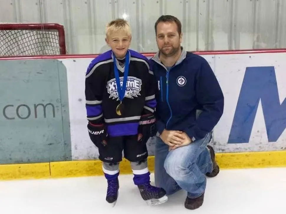 Zach Lansard and his dad on the ice